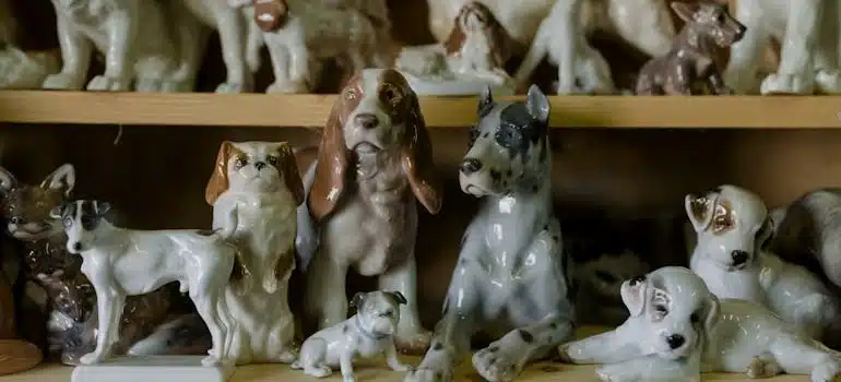 Porcelain dog statuettes on a shelf