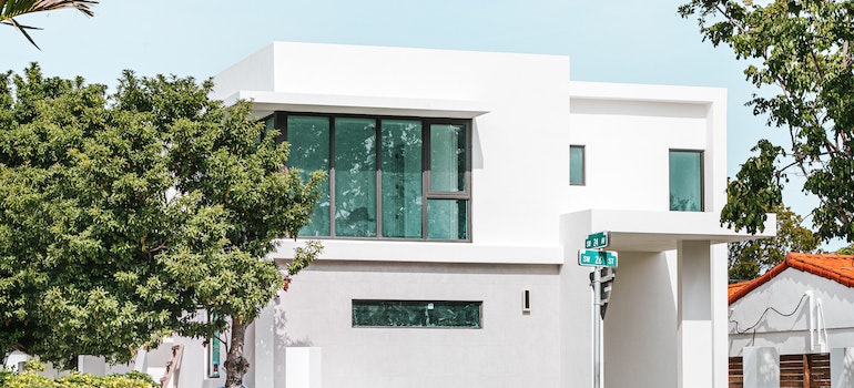 White Concrete Building Near Green Tree