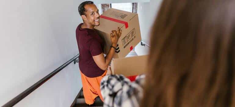 man is carrying a box