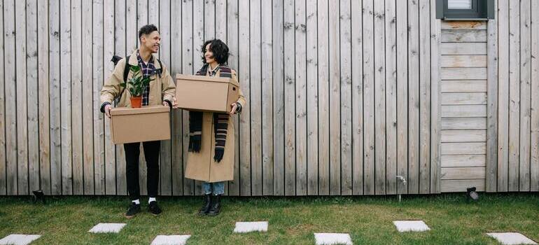 couple is standing with boxes