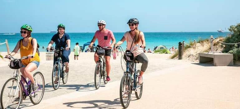 people riding bikes on the beach