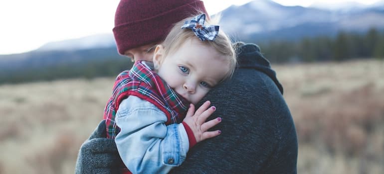 A man holding a baby;