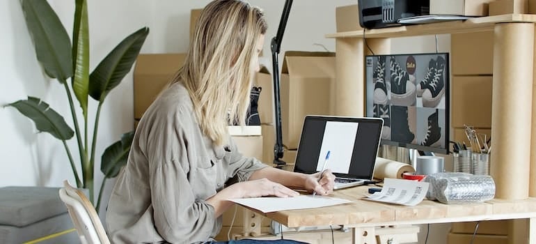 Woman busy writing on the paper