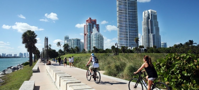 people riding a bike near the body of water
