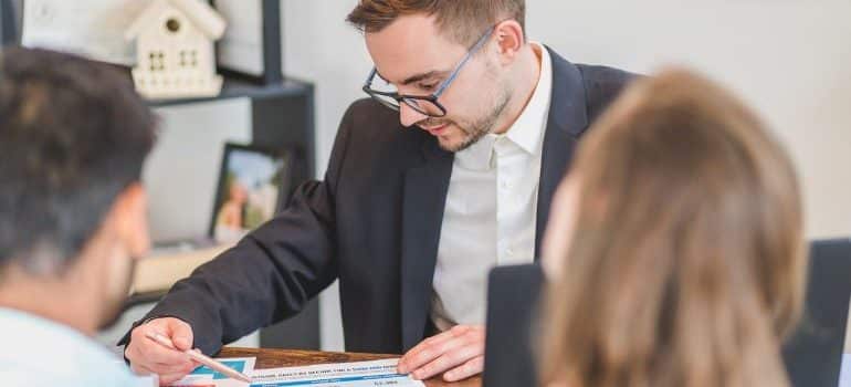 real estate agent and clients talking before buying a beach house