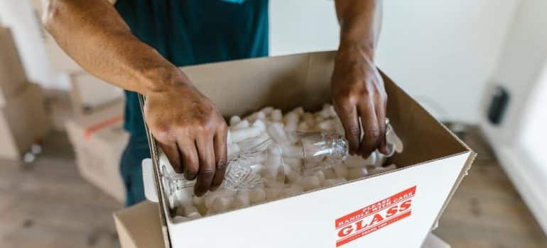 A mover packing a moving box