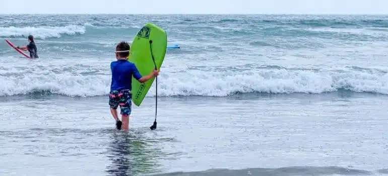 A boy at the beach after moving from Pompano Beach to Surfside