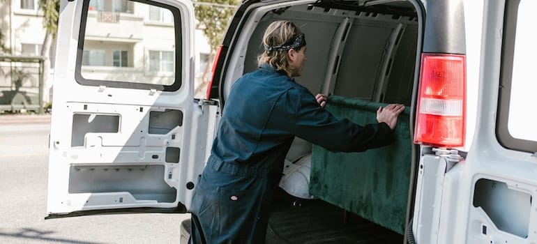 A person packing their things in a smaller moving truck they've rented for a move from Coral Springs to Aventura.