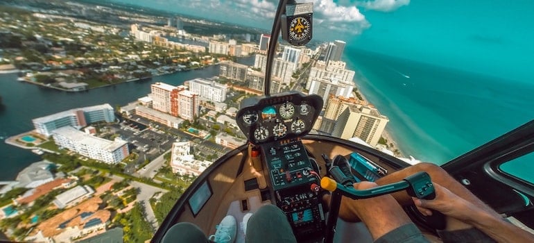 Two people riding a helicopter;