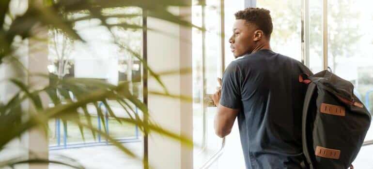 man looking out of window