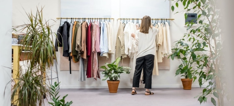 Woman buying new clothes since she is moving from Pompano Beach to a snowy city