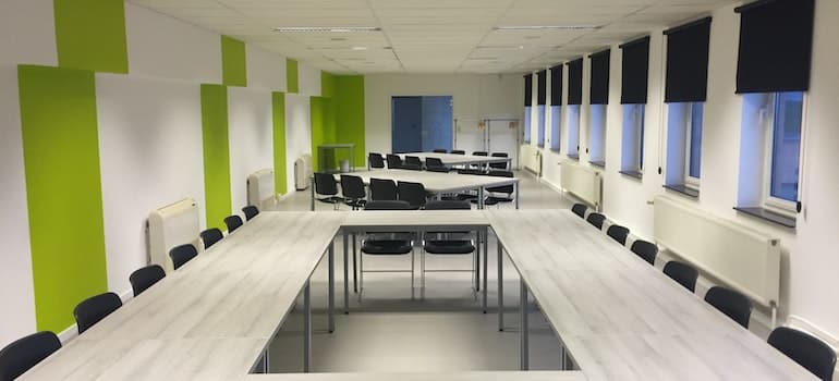 Black chairs and a white wooden table inside an office