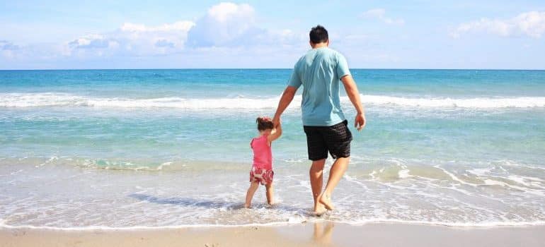 A father and a daughter on a beach