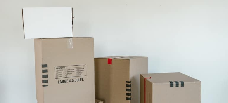 Cardboard boxes on a wooden floor used for storing office supplies after moving to Downtown Miami