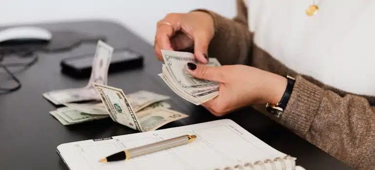 a woman calculating how to live in Miami on a smaller budget