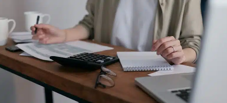 a woman calculating the cost of living in Kendall 