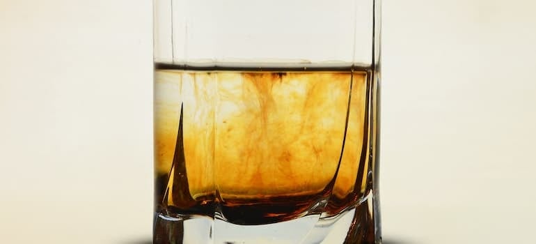 Clear glass with brown liquid