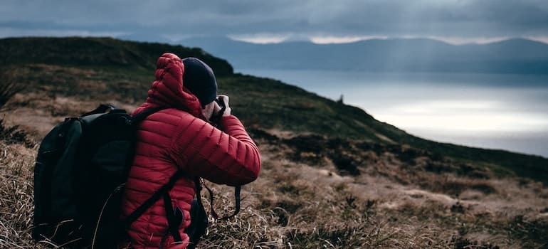 man photographing mountain