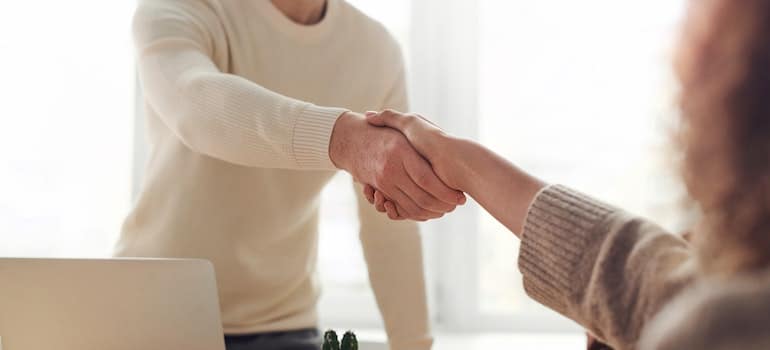 A businessman shaking hands with someone on making a deal for leaving Florida to start a business again.