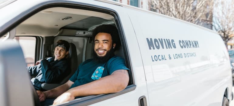 Moving company's crew sitting in a truck.