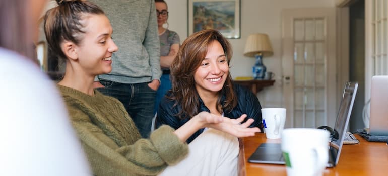 A family looking at a laptop together, researching about Homestead relocation options for a family.