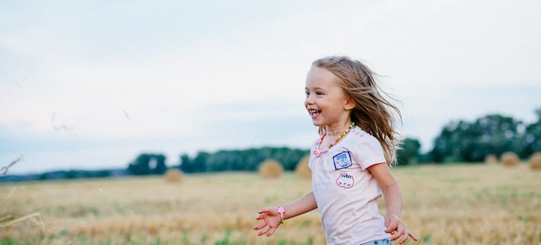 A kid running outdoors after relocating to one of the Miami suburbs.