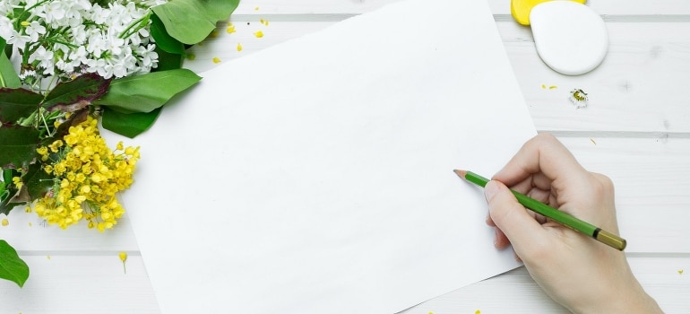 A person about to write while thinking about spring cleaning tips for an easy move