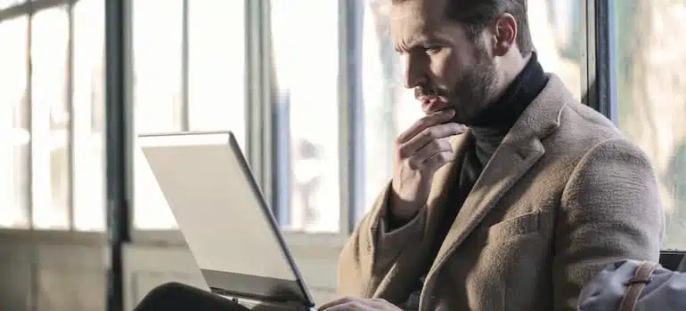 man looking at a laptop