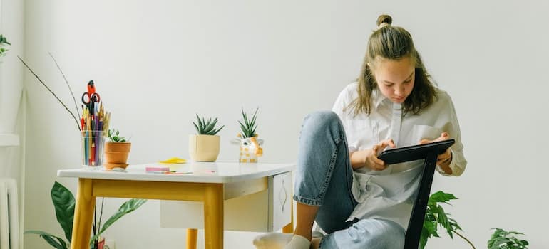 A girl looking at her tablet looking for affordable and safe storage in Miami. 