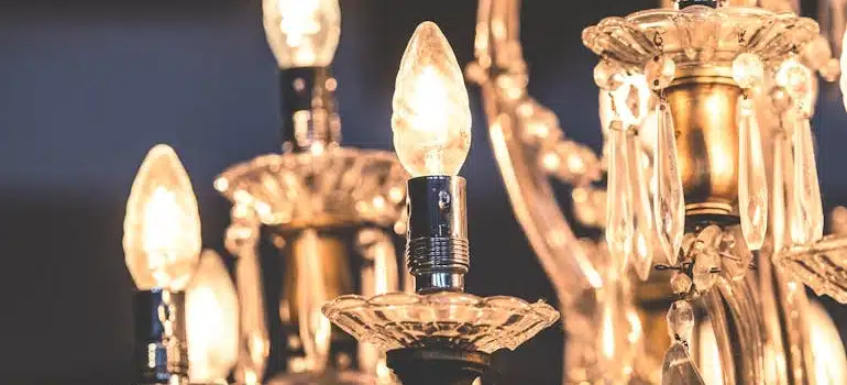 A closeup photo of a crystal chandelier with lightbulbs