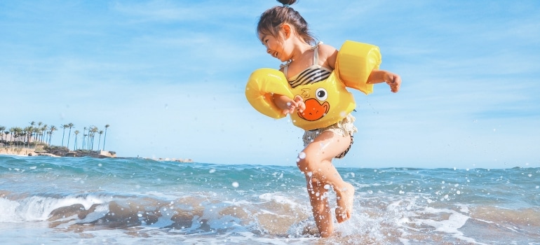 A little girl playing at the beach after moving from Miami to Surfside