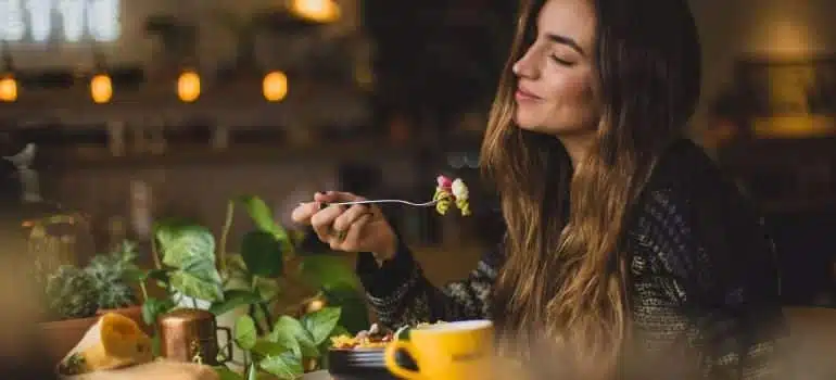 A woman enjoying food in one of the healthy restaurants in Miami Beach