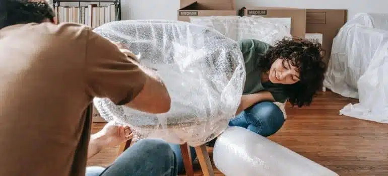 a couple trying to dispose of unwanted furniture when moving