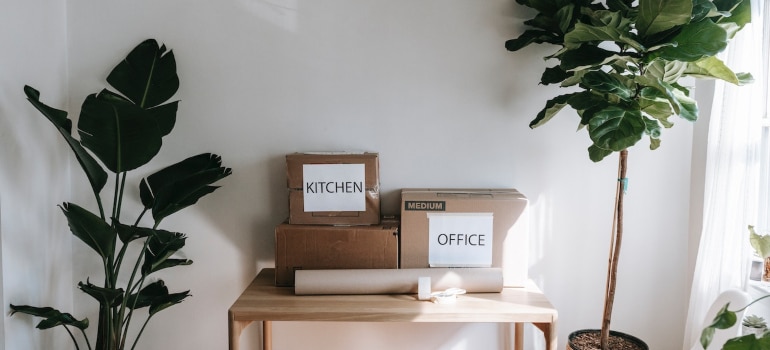 two cardboard boxes on a wooden table