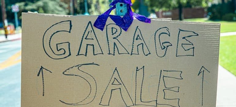 a cardboard garage sale sign
