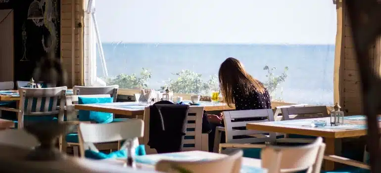 Woman siting in one of the best fine-dining restaurants in Miami
