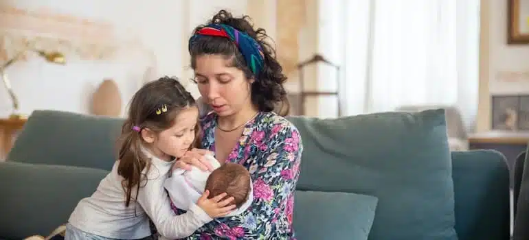 mother and children sitting inside their home