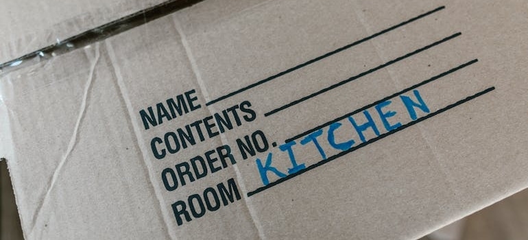 A box lid labeled "kitchen".