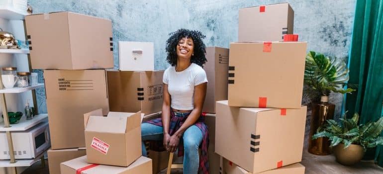 woman sitting around boxes