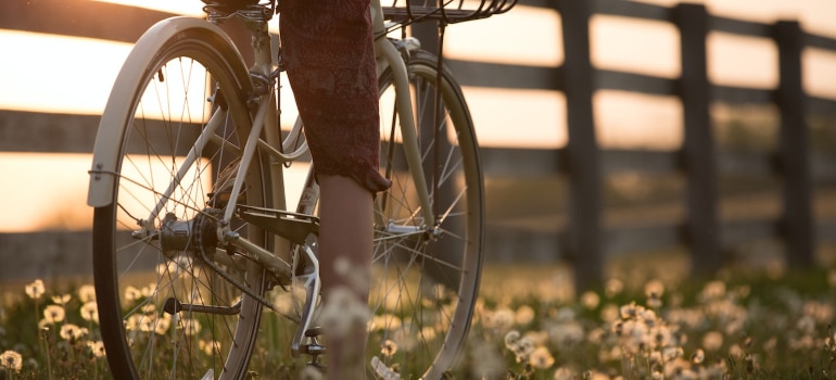 person riding bicycle near fence