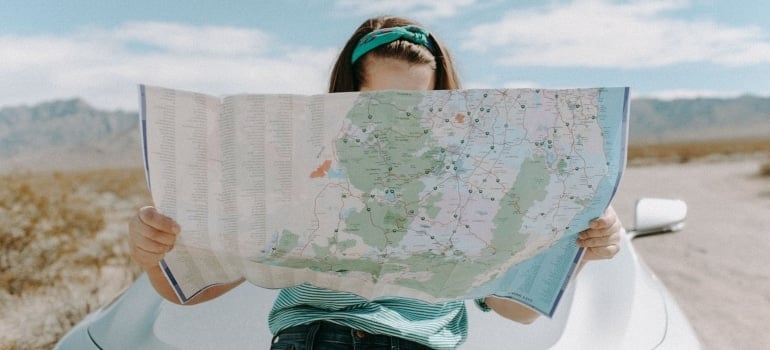 A woman looking at a map wondering where are Miami residents moving to