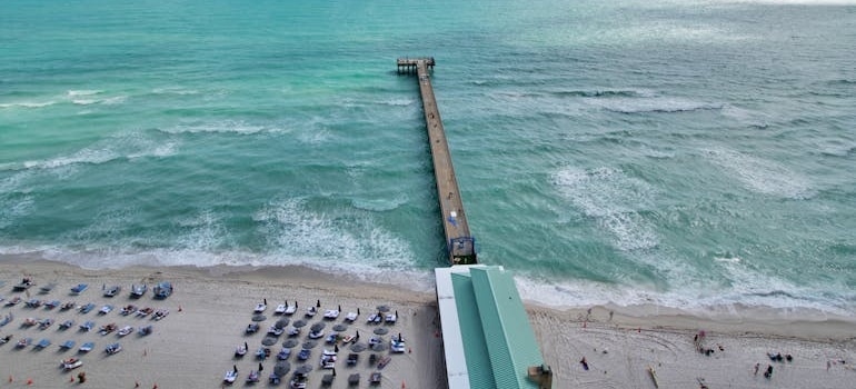 People on a beach near the Pier having fun after moving to Sunny Isles Beach