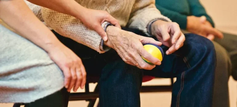A person holding an elderly person's hand