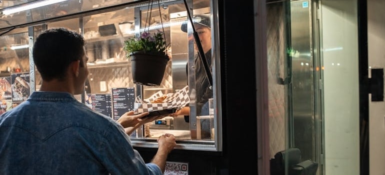 A man buying food from a food truck