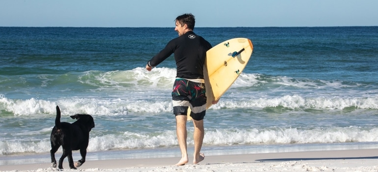 A man and his dog on the beach in one of the best Miami neighborhoods for pet-friendly living