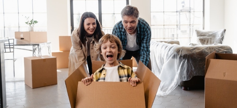 A happy family preparing for the move ready to explore the things to do in Hallandale Beach with kids after the move