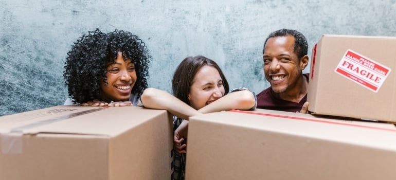 Happy people surrounded by boxes before moving from Doral to Brickell