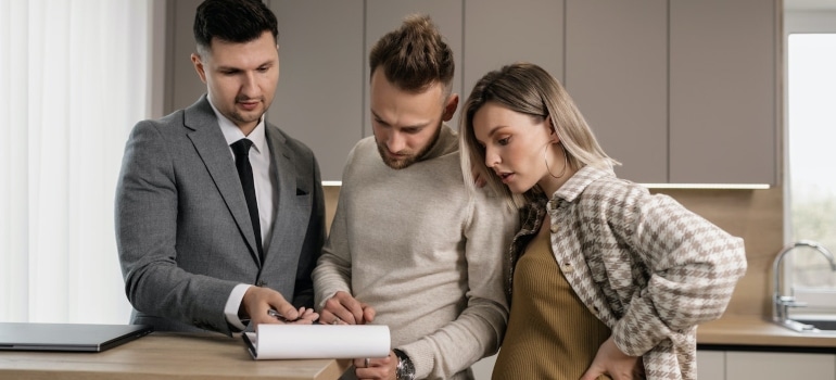 A real estate agent speaking with a couple 