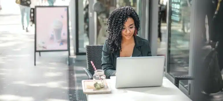 A woman searching the internet about finding office space in Miami before the move