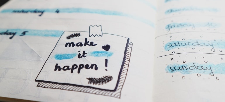 A planner with a message "make it happen"